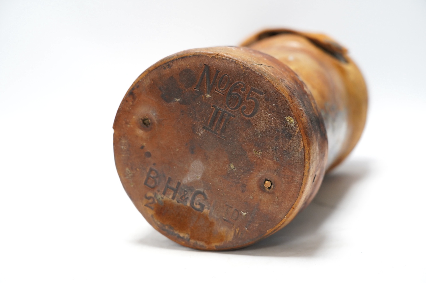 A leather powder flask, with painted Royal crest, 33cm high. Condition - poor to fair, some staining to the leather and wear at the edges